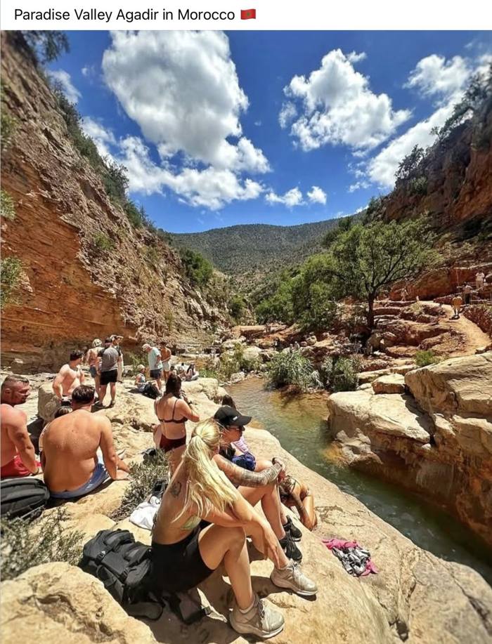 Visitors resting beside the river in the canyon